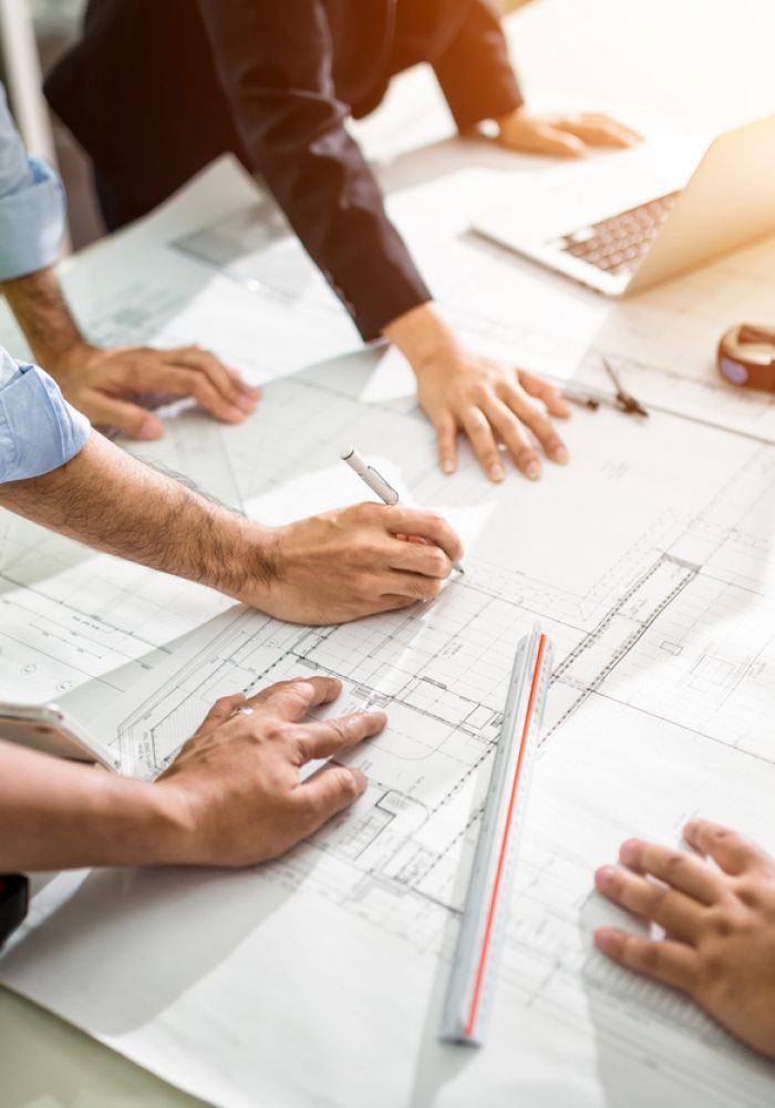 Team Engineer drawing graphic planning of interior creation project cooperating with talented teacher giving advice, working concept.