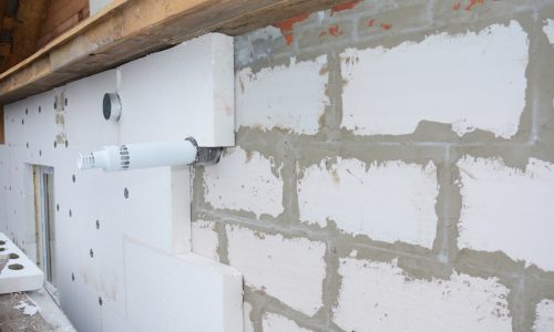 Installing rigid foam insulation around  gas convector chimney smoke pipe. Problem area.