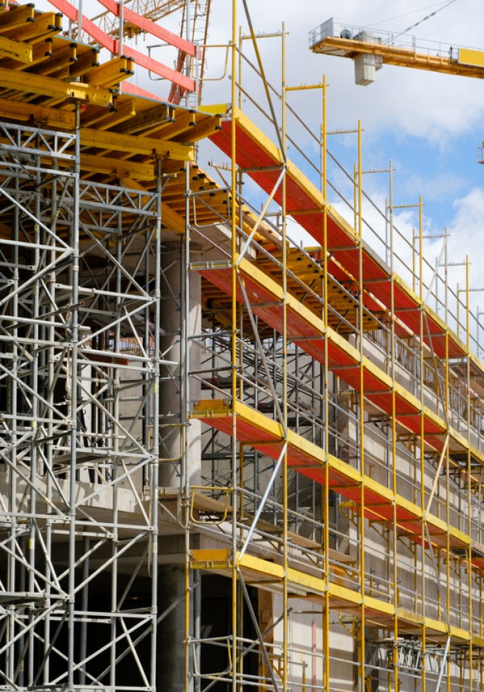 new building construction site - scaffolding and crane on building site